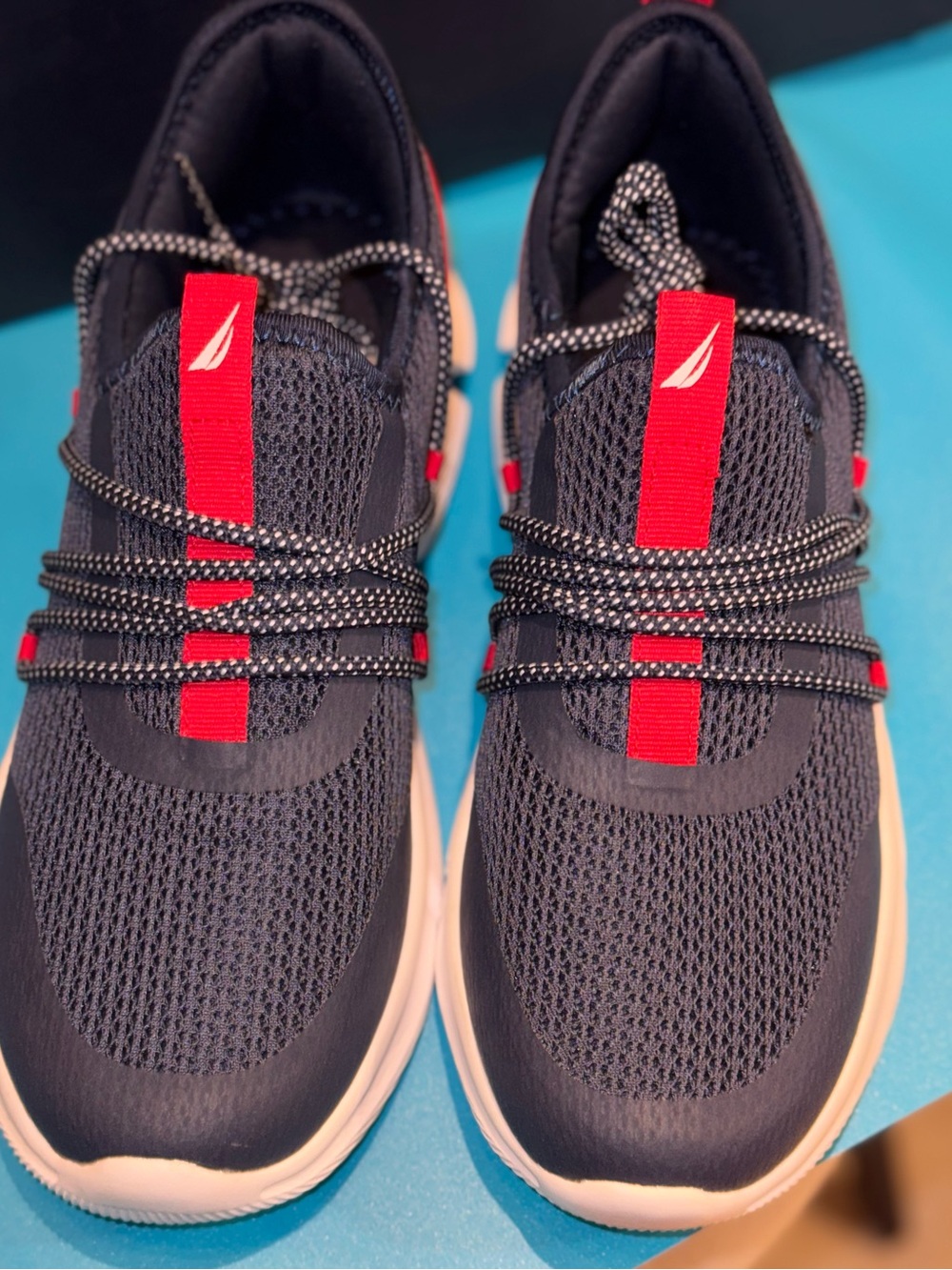Nautica Eriko mesh athletic sneakers feature a navy blue nylon upper .